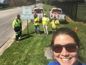 Team with Adopt-a-Highway sign